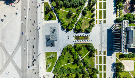 Aerial city view with roads, houses and buildings.