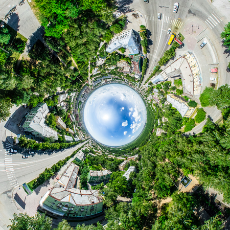 Aerial city view with crossroads and roads, houses, buildings, parks and parking lots. Sunny summer panoramic imageの写真素材