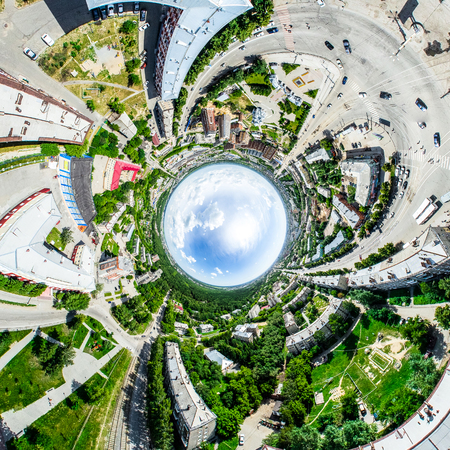 Aerial city view with crossroads and roads, houses, buildings, parks and parking lots. Sunny summer panoramic imageの写真素材
