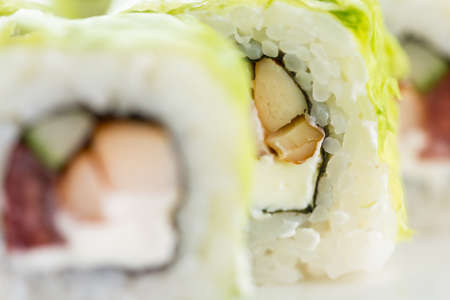 Sushi set and composition at white background. Japanese food restaurant, sushi maki gunkan roll...