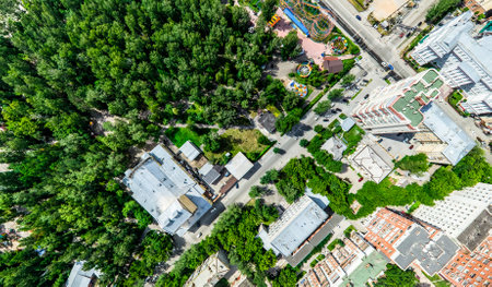 Aerial city view with crossroads and roads, houses, buildings, parks and parking lots, bridges. Helicopter drone shot. Wide Panoramic image.の写真素材