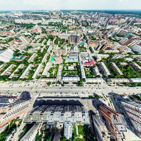 Aerial city view with crossroads and roads, houses, buildings, parks and parking lots, bridges. Helicopter drone shot. Wide Panoramic image.の写真素材
