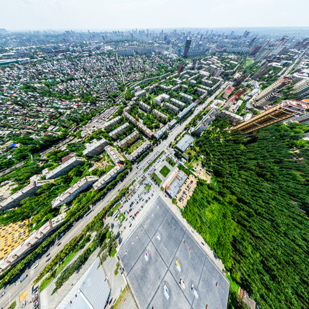 Aerial city view with crossroads and roads, houses, buildings, parks and parking lots, bridges. Helicopter drone shot. Wide Panoramic image.の写真素材