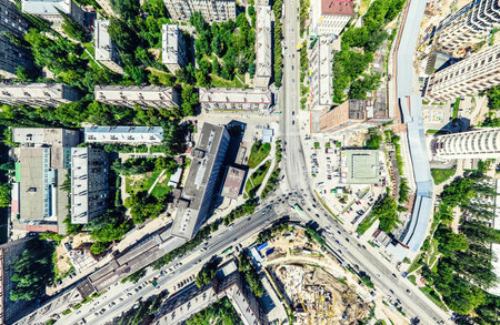 Aerial city view with crossroads and roads, houses, buildings, parks and parking lots, bridges. Helicopter drone shot. Wide Panoramic image.の写真素材