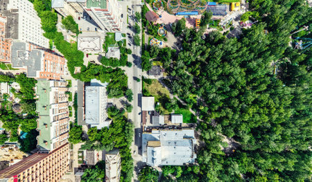 Aerial city view with crossroads and roads, houses, buildings, parks and parking lots, bridges. Helicopter drone shot. Wide Panoramic image.の写真素材