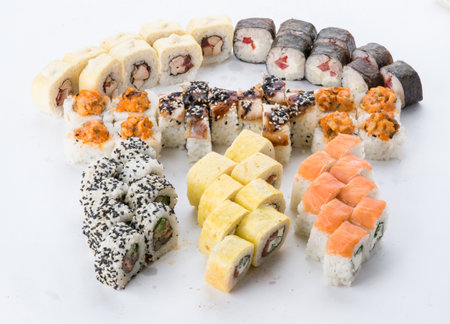 Sushi set and composition at white background. Japanese food restaurant, sushi maki gunkan roll plate or platter set.の写真素材