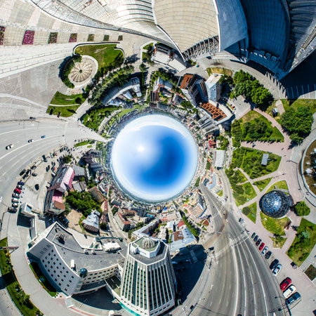 Aerial city view with crossroads, roads, houses, buildings, parks and parking lots. Copter drone helicopter shot. Panoramic wide angle image.の写真素材