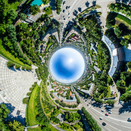 Aerial city view with crossroads, roads, houses, buildings, parks and parking lots. Copter drone helicopter shot. Panoramic wide angle image.の写真素材