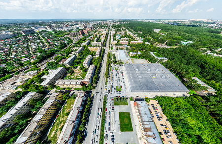 Aerial city view with crossroads and roads, houses, buildings, parks and parking lots, bridges. Helicopter drone shot. Wide Panoramic image.の写真素材
