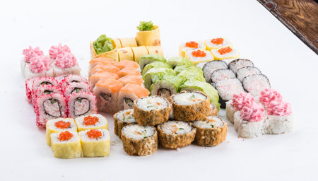 Sushi set and composition at white background. Japanese food restaurant, sushi maki gunkan roll plate or platter set.の写真素材