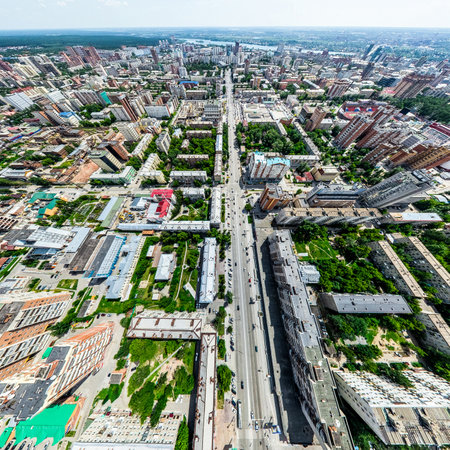 Aerial city view with crossroads and roads, houses, buildings, parks and parking lots, bridges. Helicopter drone shot. Wide Panoramic image.の写真素材