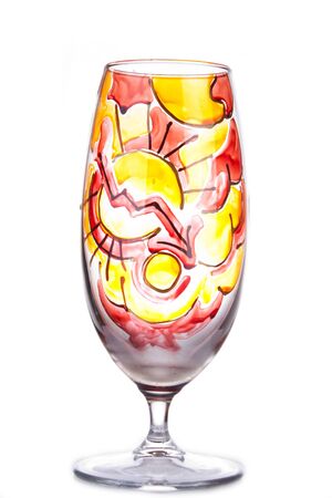 Design glass decdorated in red, orange and yellow and isolated on whiteの写真素材