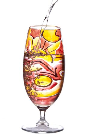 Design glass decdorated in red, orange and yellow and isolated on whiteの写真素材