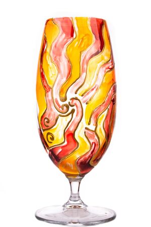 Design glass decdorated in red, orange and yellow and isolated on whiteの写真素材