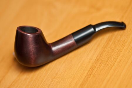 Original smoking pipe on wood background. Selective focus.の写真素材