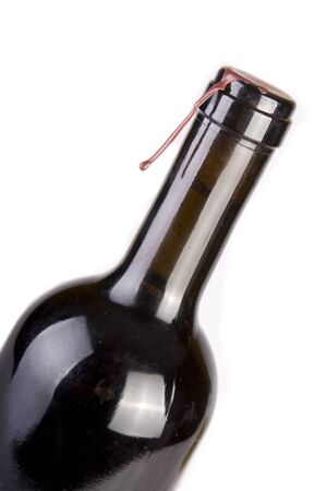 Unopened bottled of red wine isolated on whiteの写真素材
