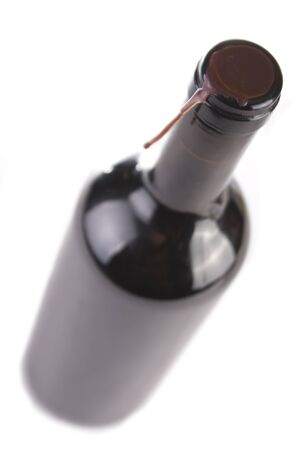 Unopened bottled of red wine isolated on white. Selective focus.の写真素材