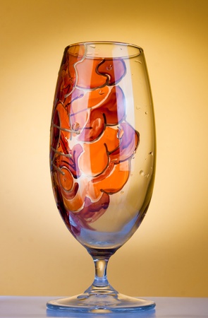 Design glass decdorated in red, orange and yellow and isolated on whiteの写真素材