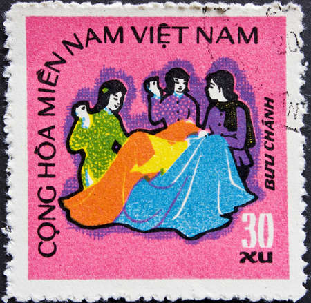 Post stamp from Vietnam - women sewing a communist flagの写真素材