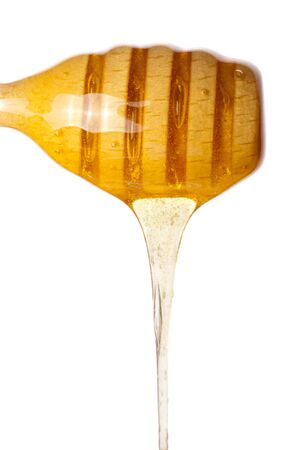 Real honey stick  isolated on whiteの写真素材