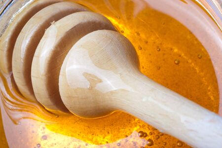 Real honey in a jar isolated on whiteの写真素材