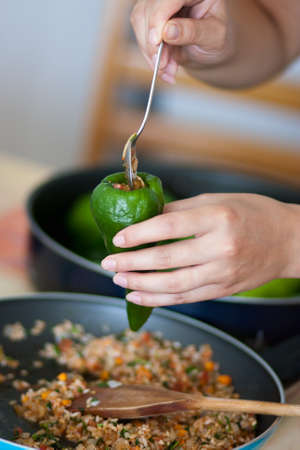 Woman cooking stuffed pepperの写真素材
