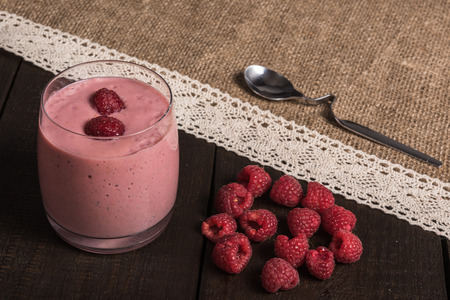 raspberry - banana smoothie on korichnevom the background of natural wood, laceの写真素材