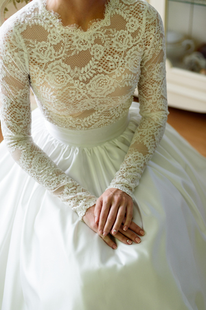 female hands on the wedding dressの写真素材