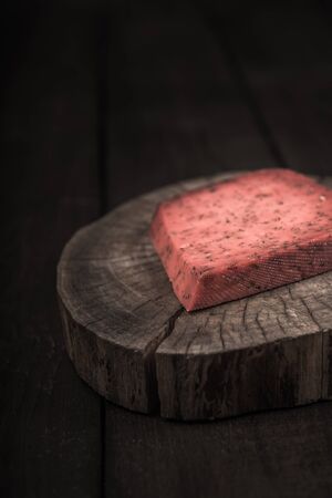 red hot tomato cheese pesto on wooden end of a treeの写真素材