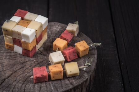 many kinds of cheeses on wooden end of a treeの写真素材