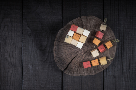 many kinds of cheeses on wooden end of a treeの写真素材