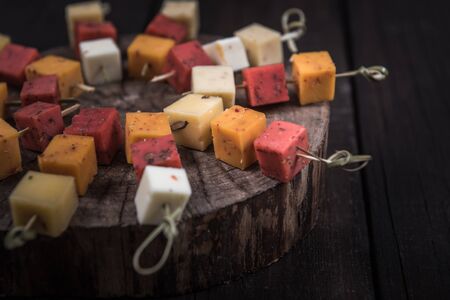 many kinds of cheeses on wooden end of a treeの写真素材