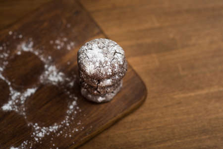 chocolate cookies with sugar powder on wooden kitchen Boardの写真素材