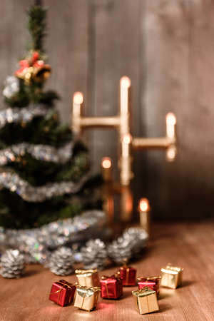 Christmas decorative tree is adorned with rain stands on the table with a lit lamp lightsの写真素材