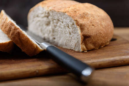 grain bread is sliced on the Boardの写真素材
