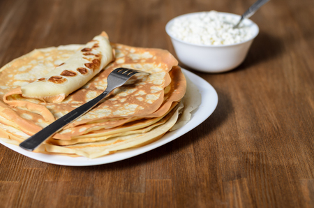 homemade pancakes on a white plate with cottage cheeseの写真素材
