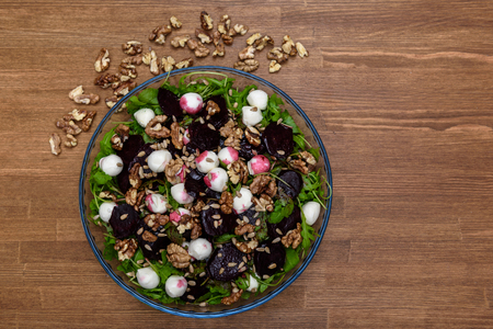 arugula salad with beet quail eggs and nutsの写真素材