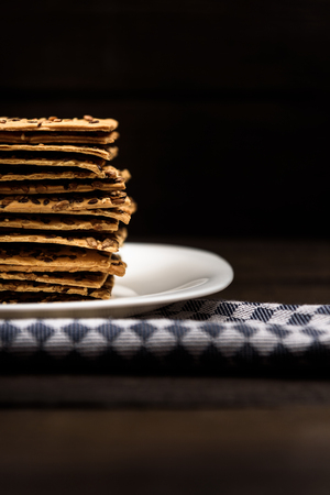cookies with sunflower seeds and sesame seeds on a white plate with checkered napkin