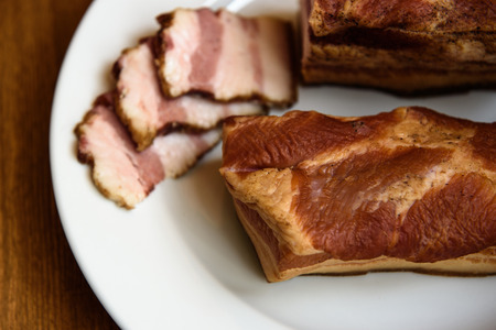 smoked pork ribs on white plate on wooden backgroundの写真素材