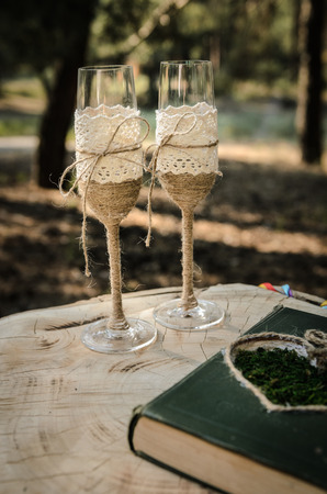 wedding glasses with twine are drawn on the stumpの写真素材