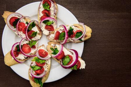 bruschetta with tomatoes, cheese, onions and parsley