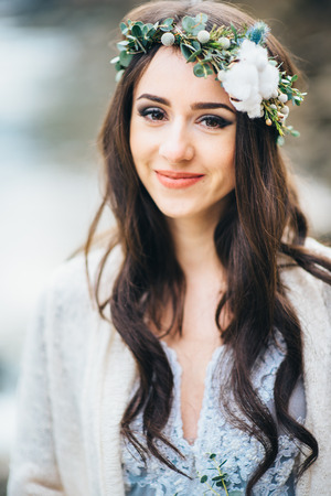 happy bride with long hair smiles with wreath on her headの写真素材