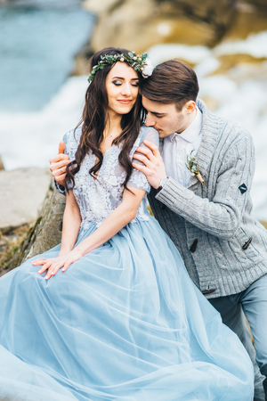 the groom kisses the bride shoulder, she closed her eyesの写真素材