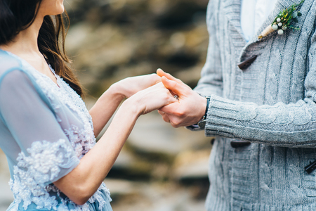 the groom holds the bride in his hands, lovers holding handsの写真素材