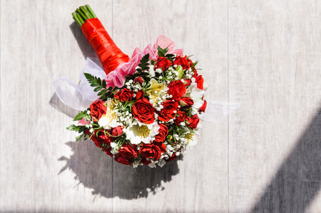 brides bouquet on a vintage wooden floor in the sunlightの写真素材