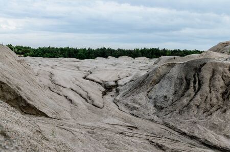 heap of gravel with water stains from rain on a background of blue sky careersの写真素材