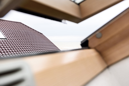 open wooden attic window overlooking the street