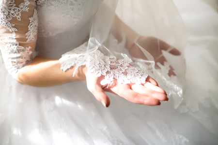 the bride holds in her hands and sees lace veilの写真素材