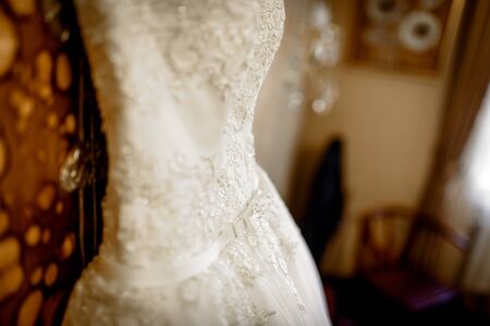 the bride's room with the wedding dress and bedの写真素材
