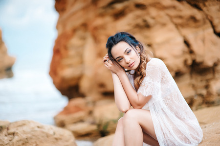 young girl bride in her underwear on the shore of the sea dreams of the futureの写真素材